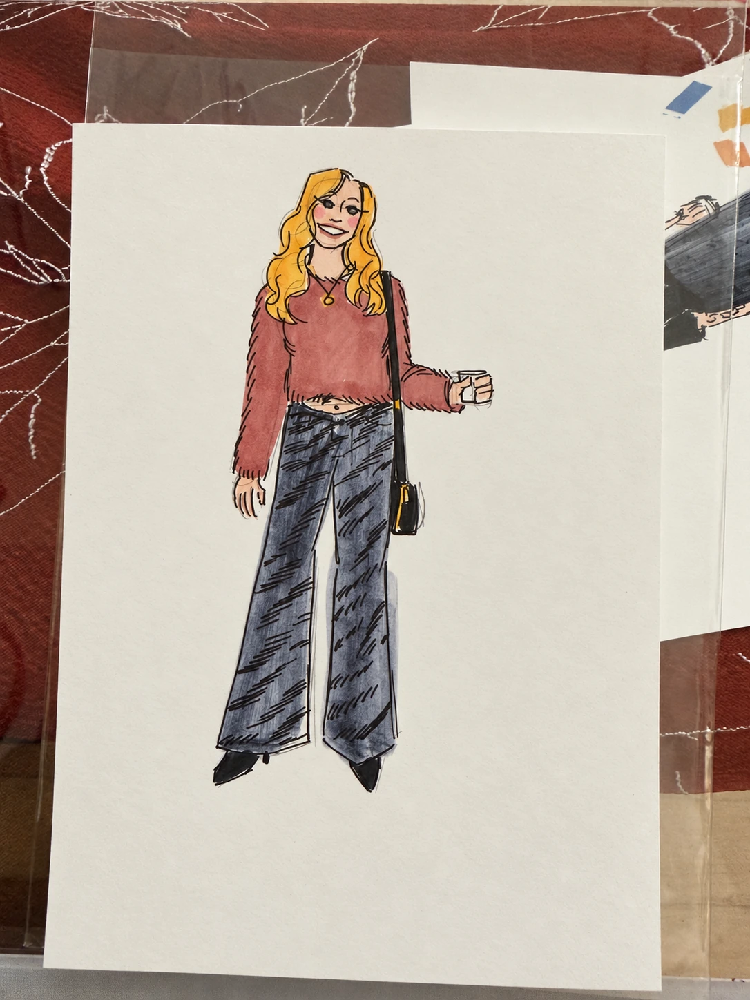 Color fashion sketch on paper of a woman in a rose top and wide-leg jeans