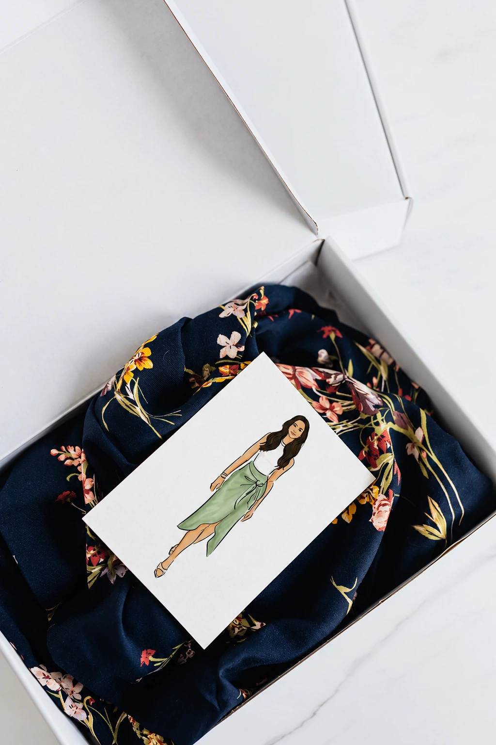 Fashion portrait presented with a retail gift box and patterned fabric