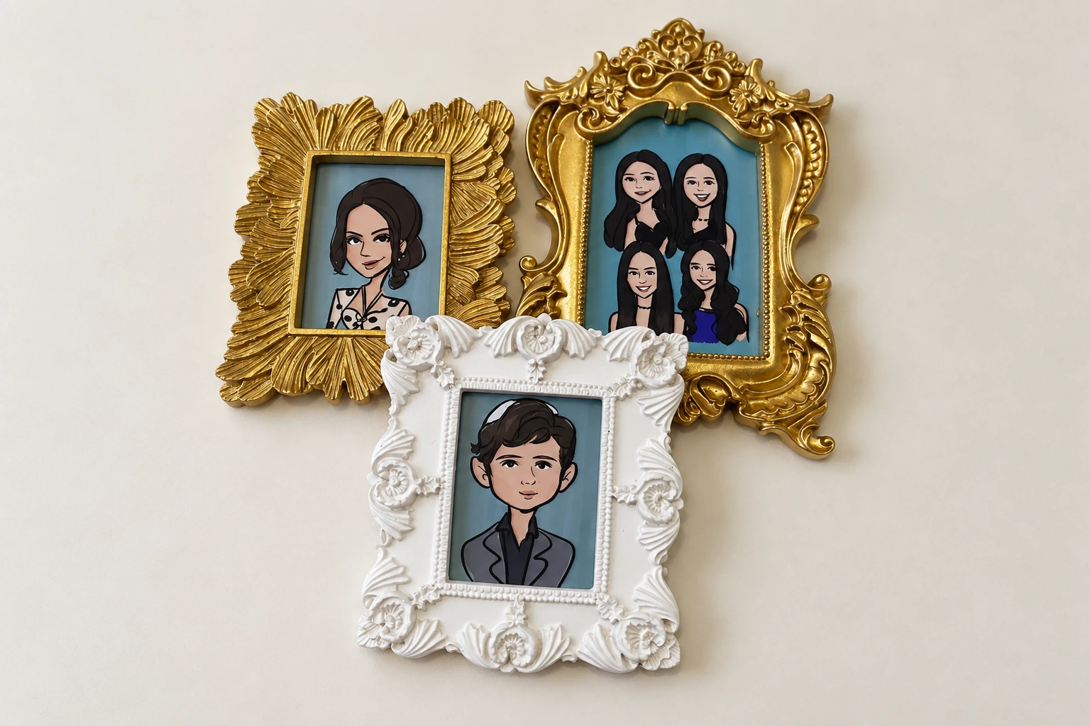 Three assorted miniature portrait frames lying flat on a smooth table