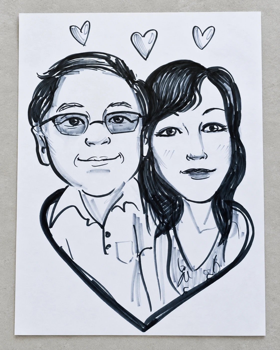 Hand-drawn couple caricature with glasses and a heart outline