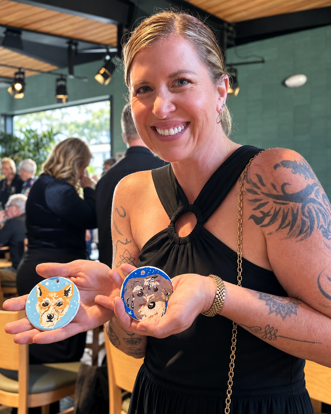 Guest presenting two round hand-painted dog portrait keepsakes
