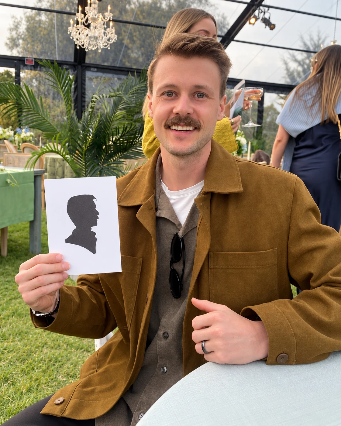 Guest holding his black profile silhouette on a white card