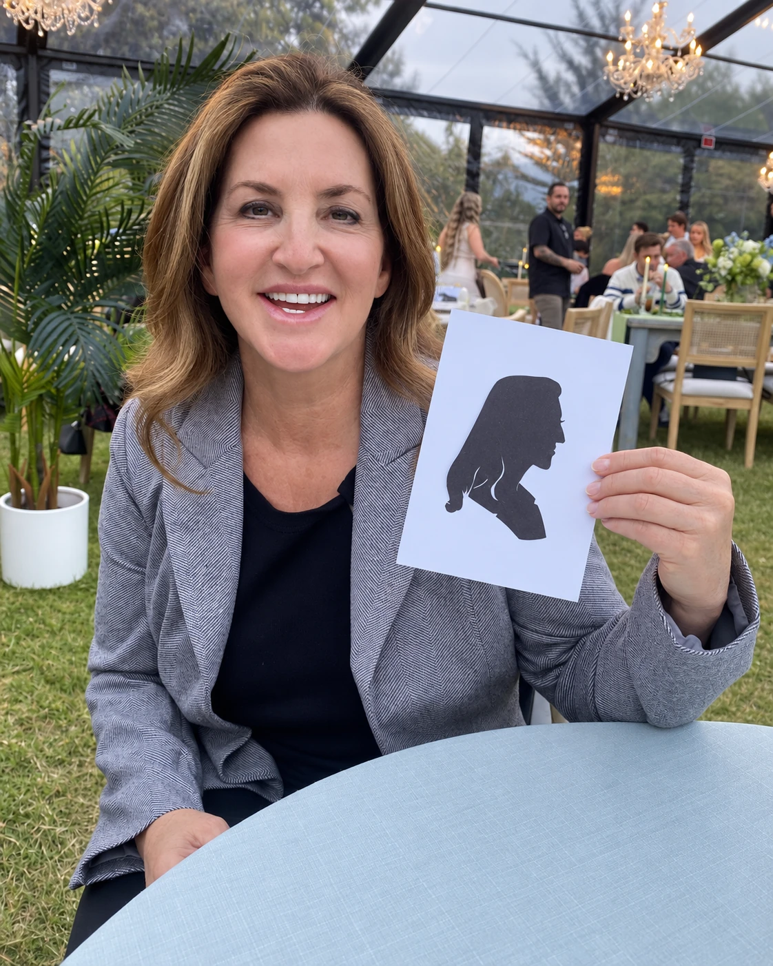 Guest holding her black profile silhouette card