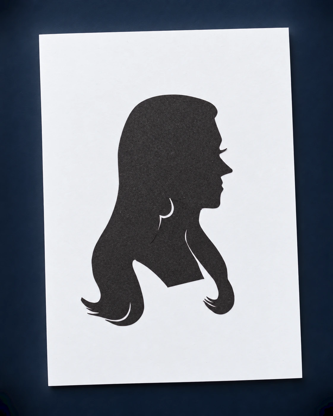 A black profile silhouette mounted on a white card