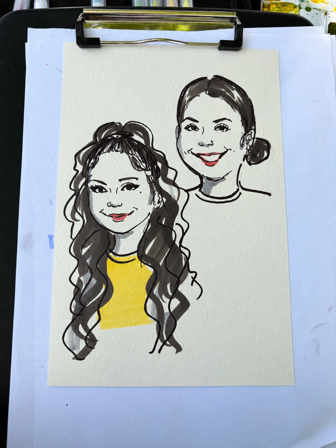 Hand-drawn portrait of two women on a clipboard