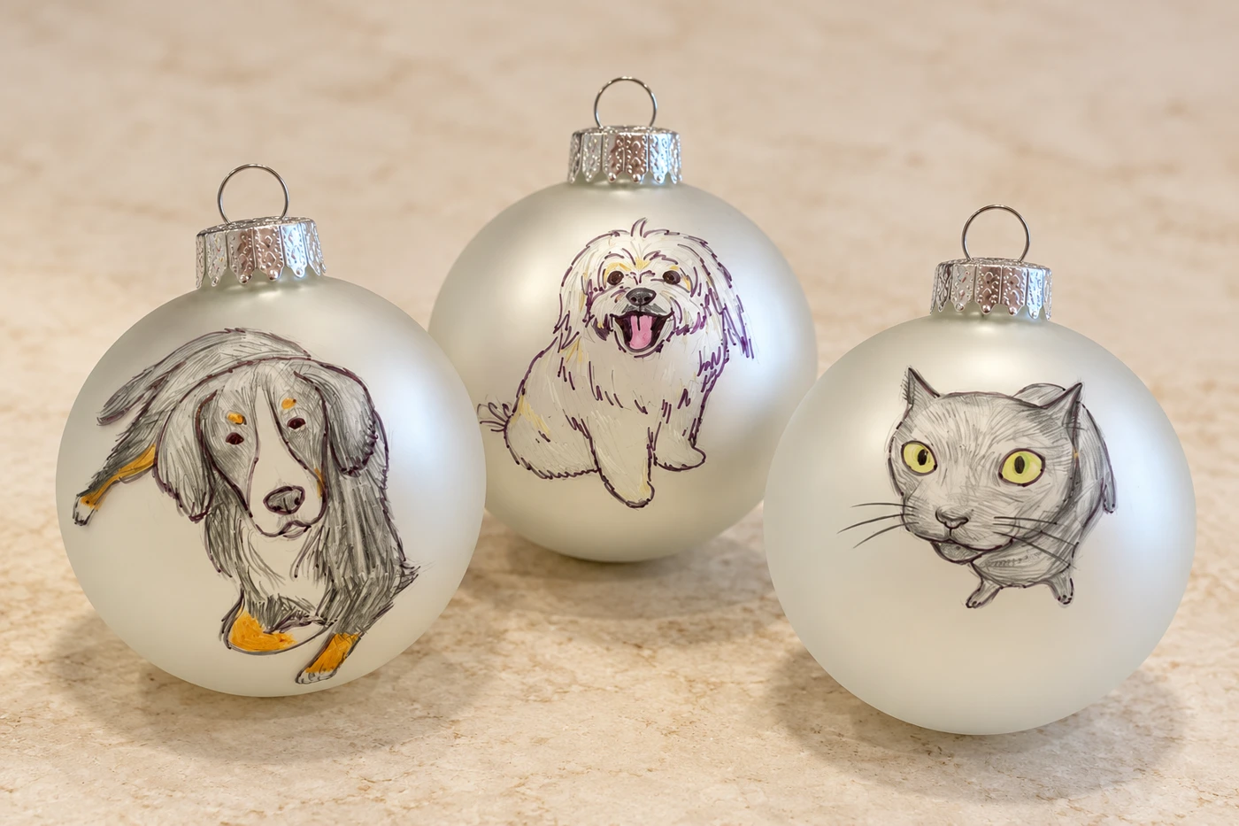 Three silver ornaments painted with cat and dog portraits