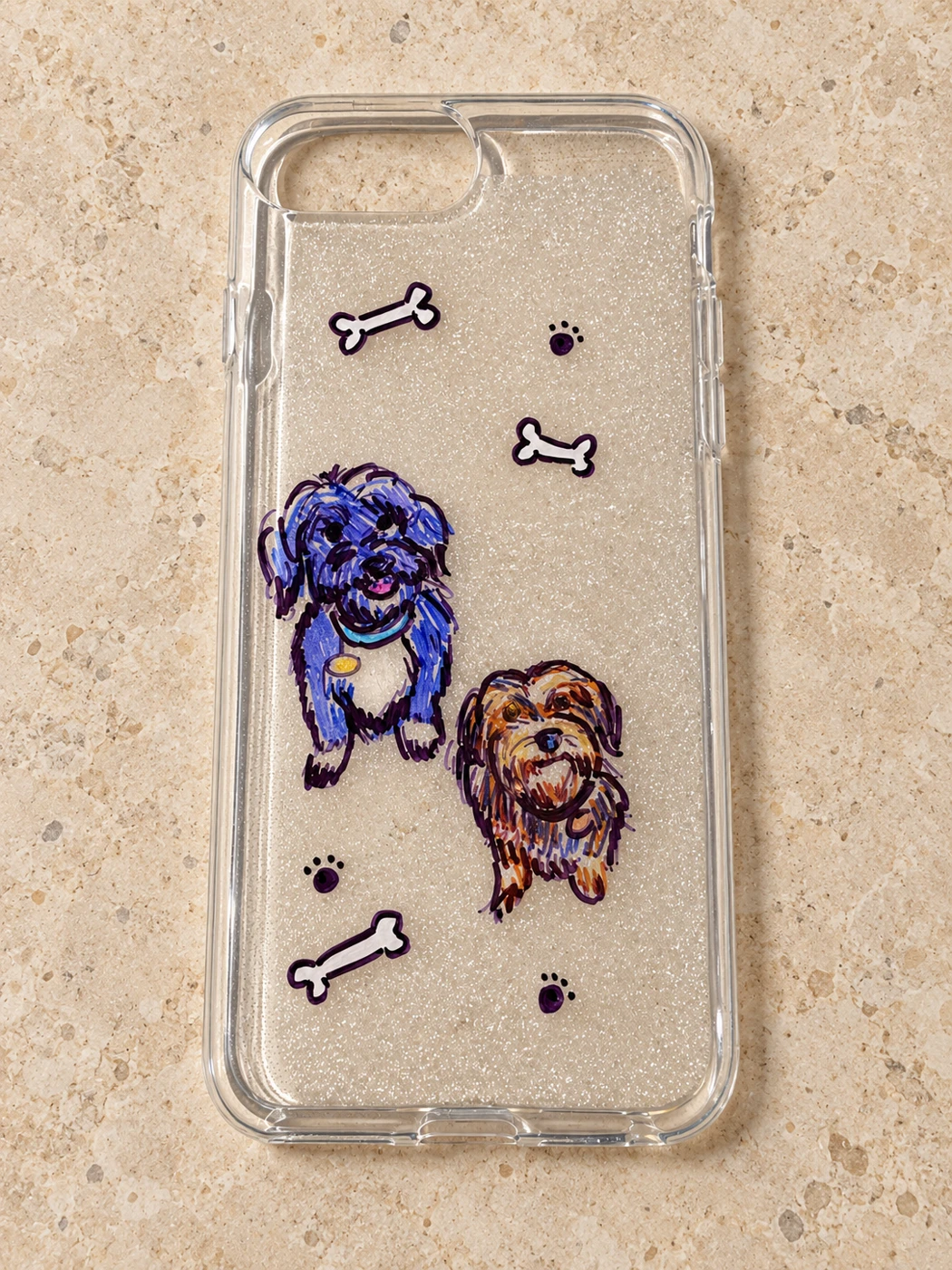 Two colorful dog portraits on a clear phone case