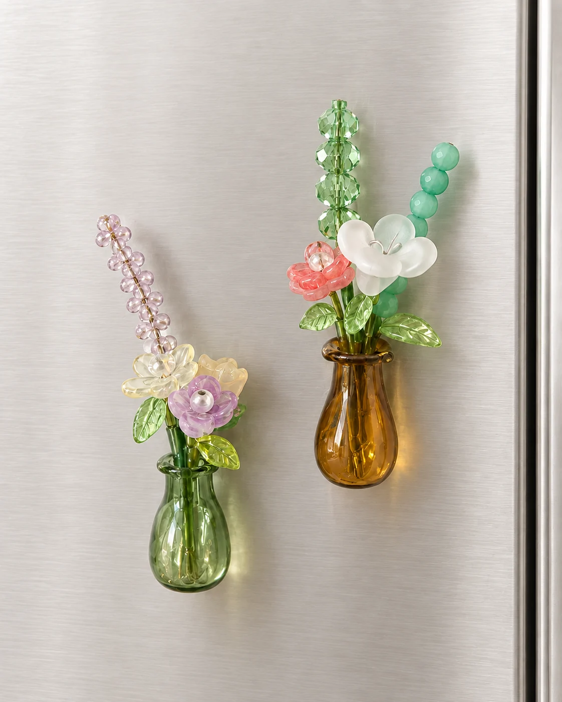 Two beaded flower bouquets in magnet vases on a refrigerator