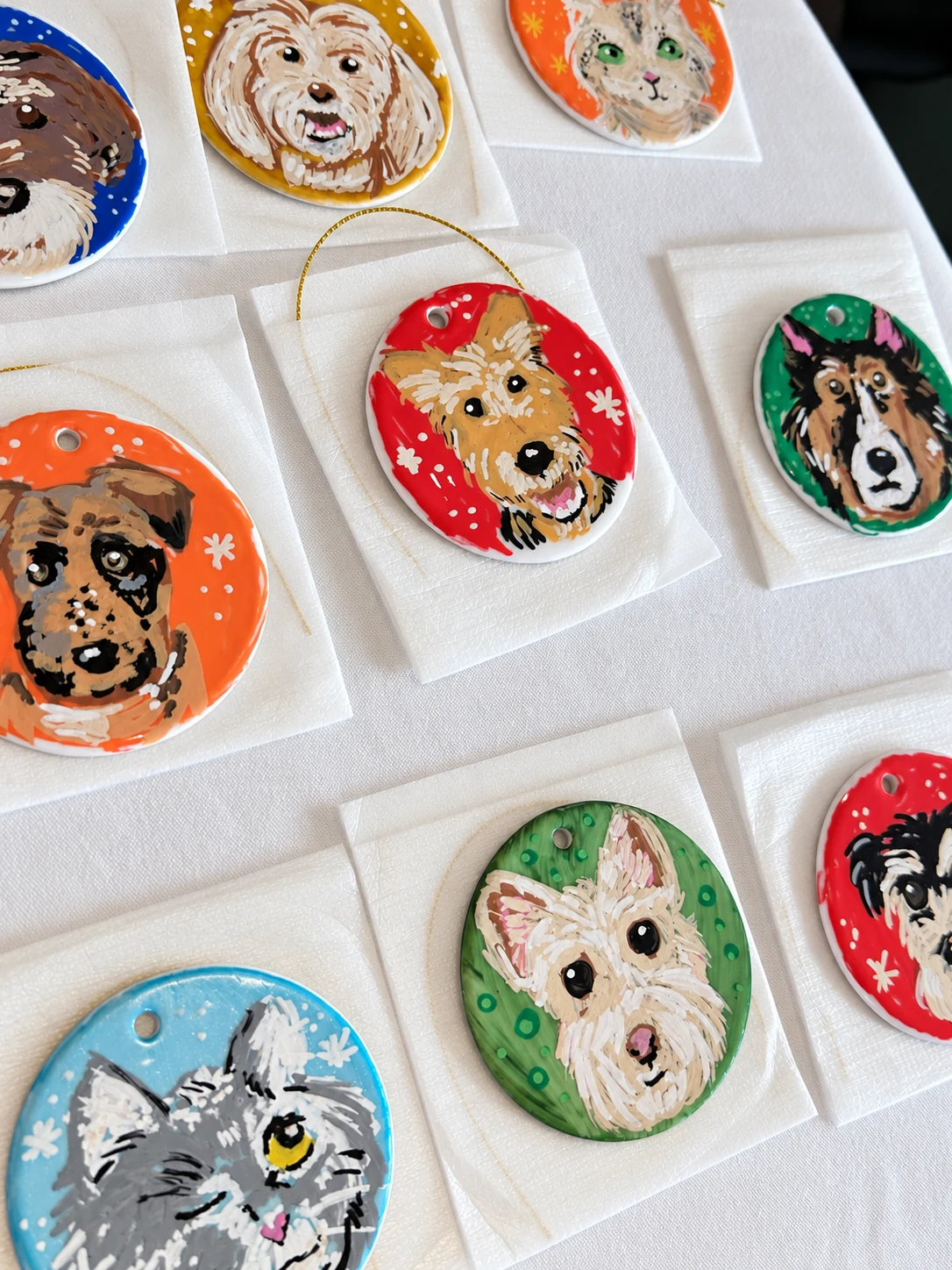 Hand-painted dog and cat portraits on round ornaments