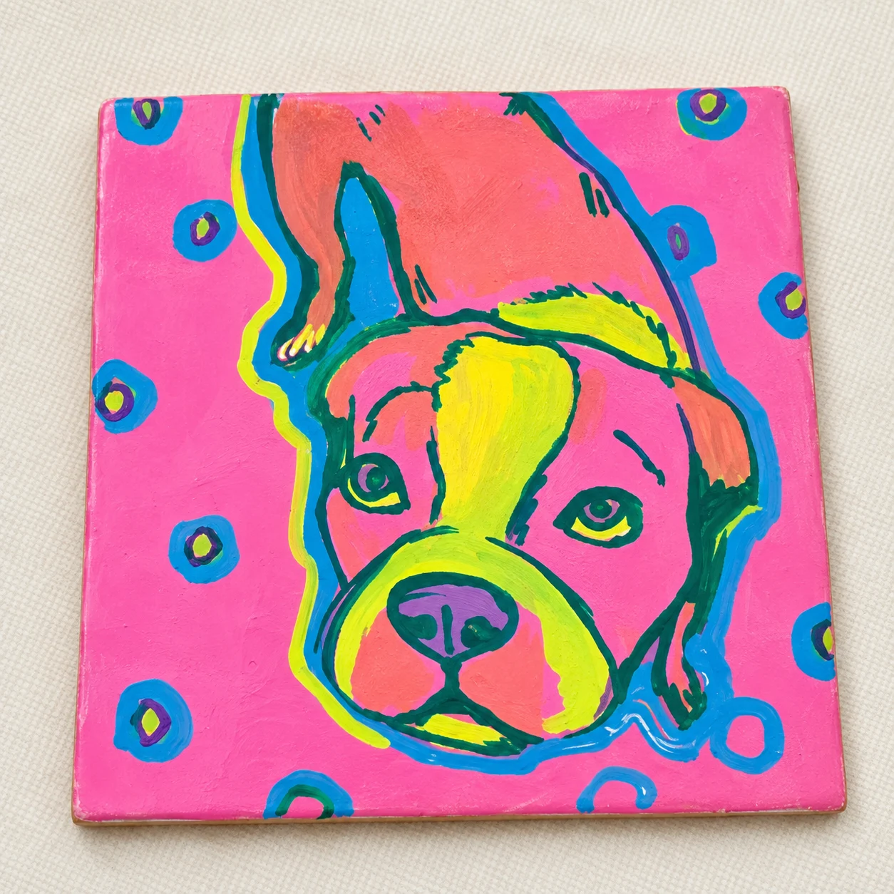 A dog painted in pop art style on a pink tile