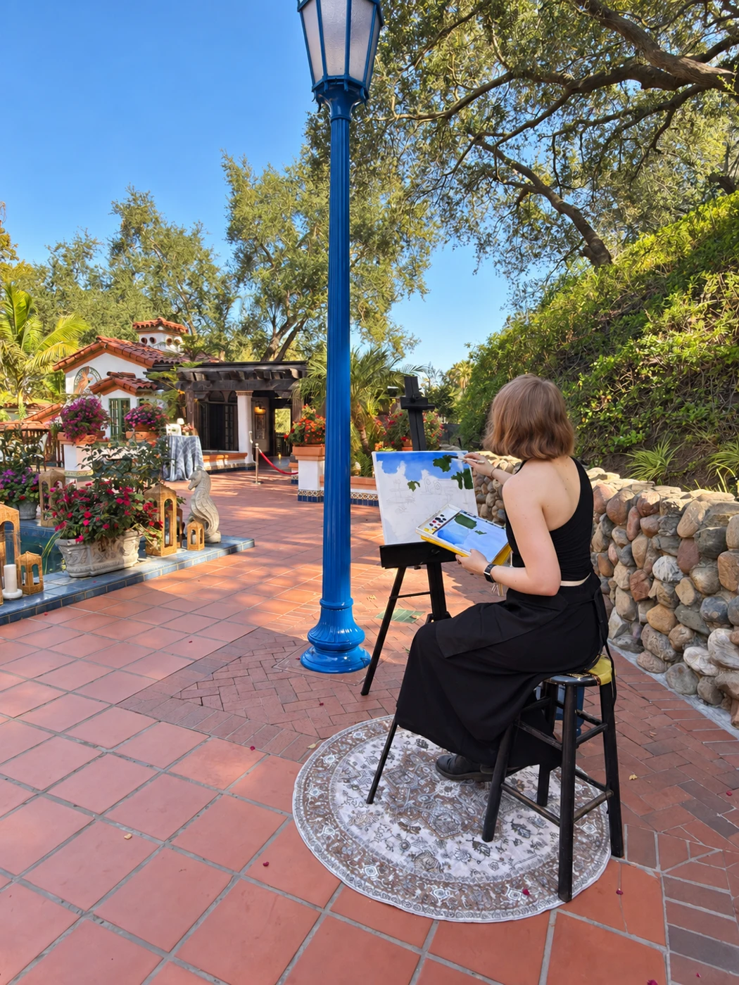 Artist painting a courtyard scene beside a blue lamp